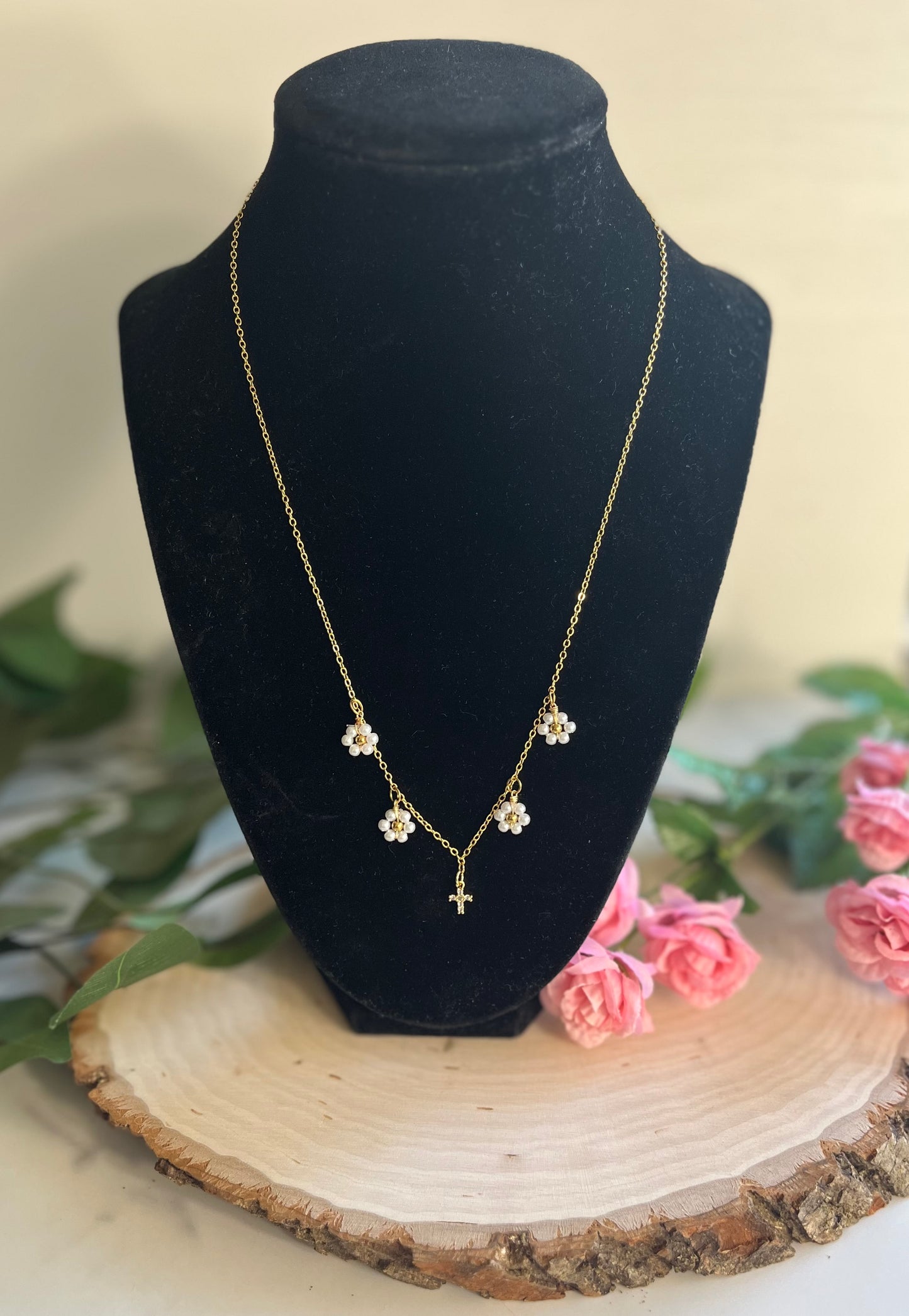 Gold Necklace with 16K gold pendant featuring daisies and a cross.