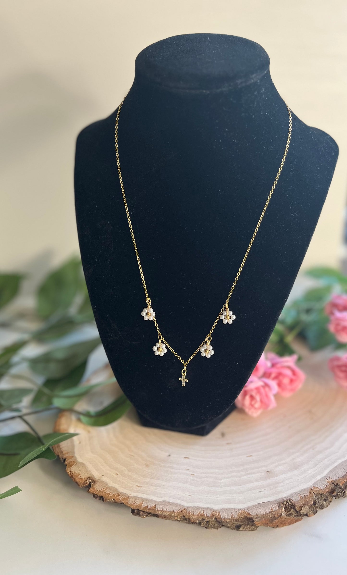Gold Necklace with 16K gold pendant featuring daisies and a cross.