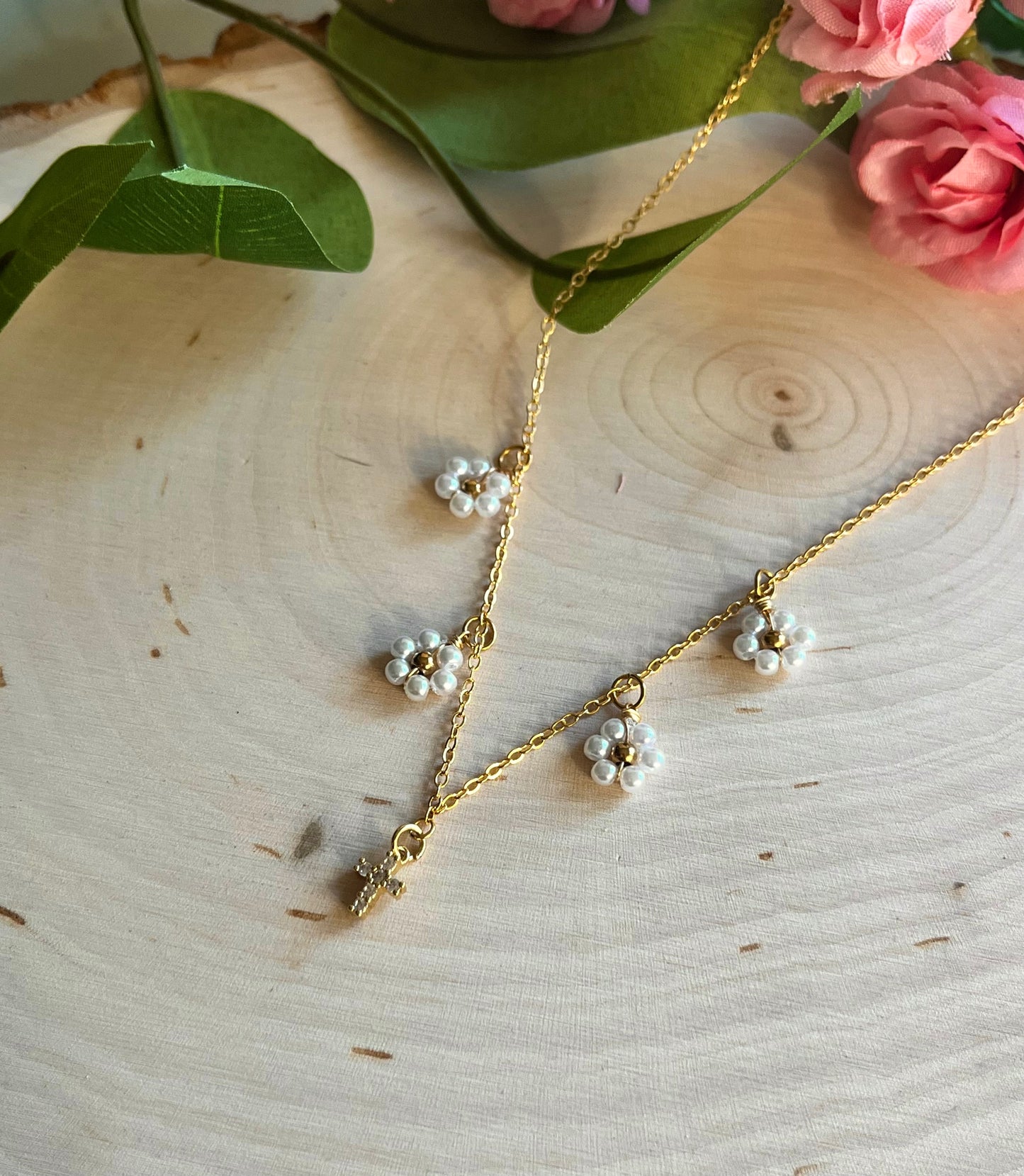 Gold Necklace with 16K gold pendant featuring daisies and a cross.