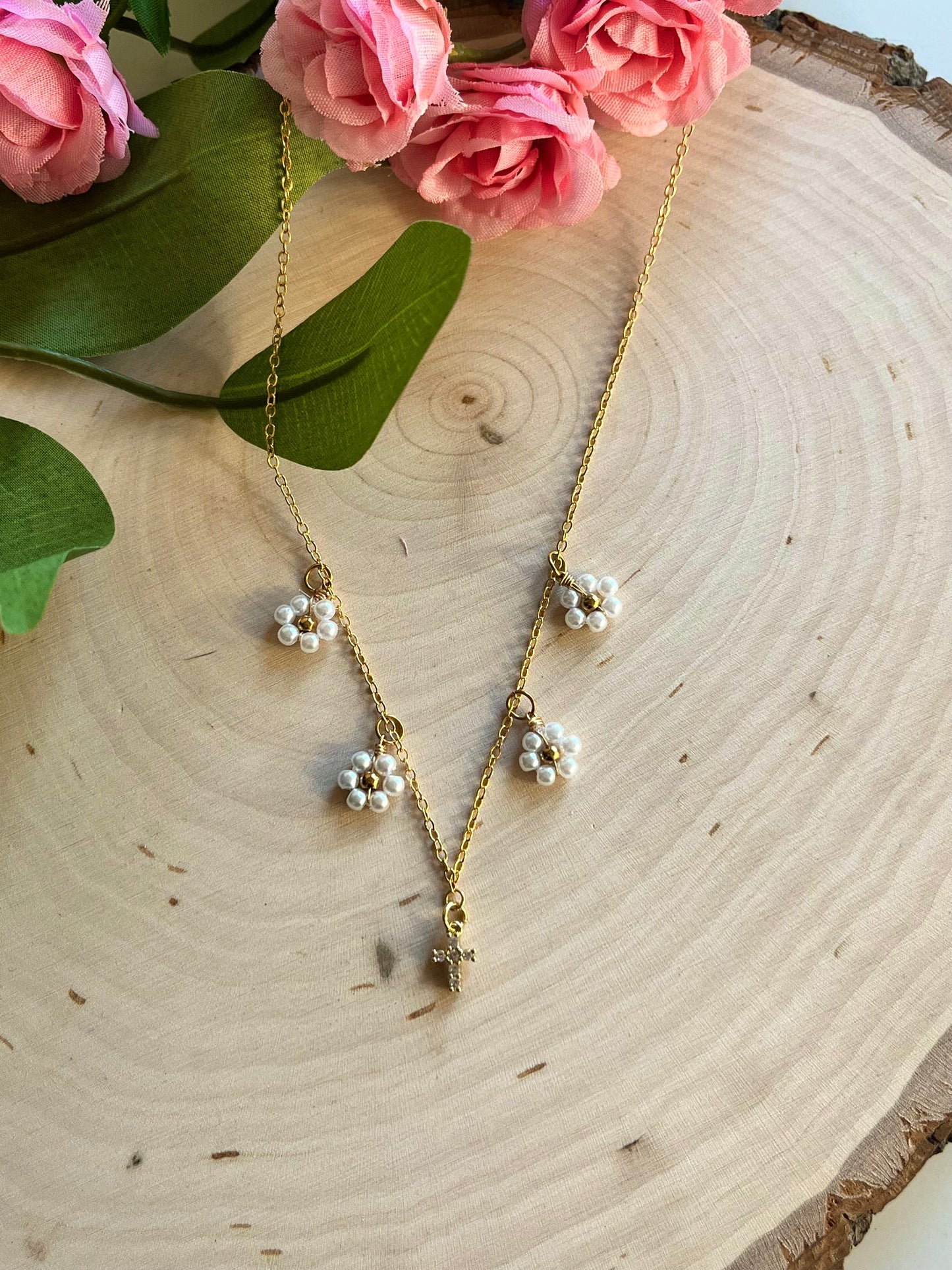 Gold Necklace with 16K gold pendant featuring daisies and a cross.