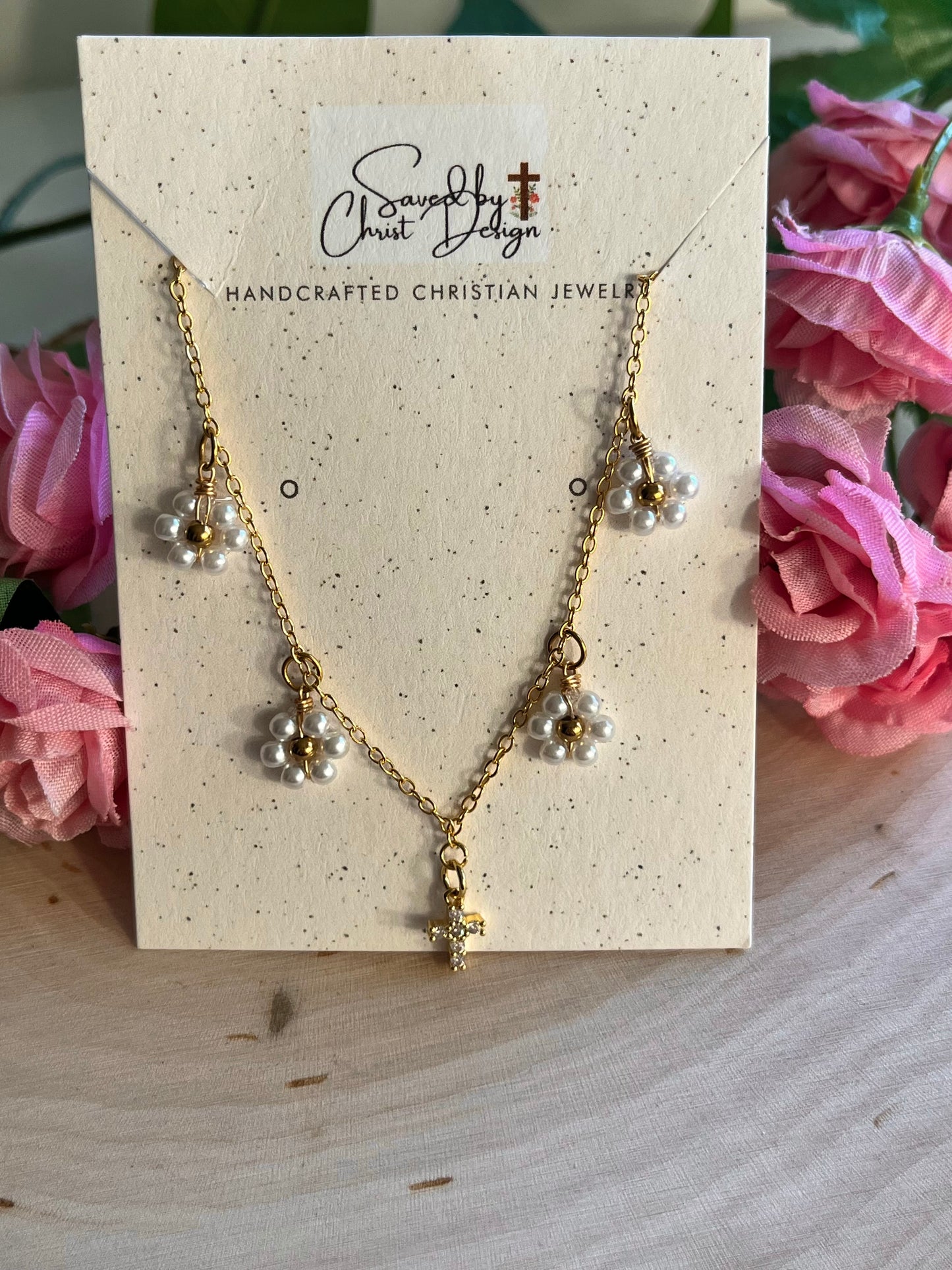 Gold Necklace with 16K gold pendant featuring daisies and a cross.