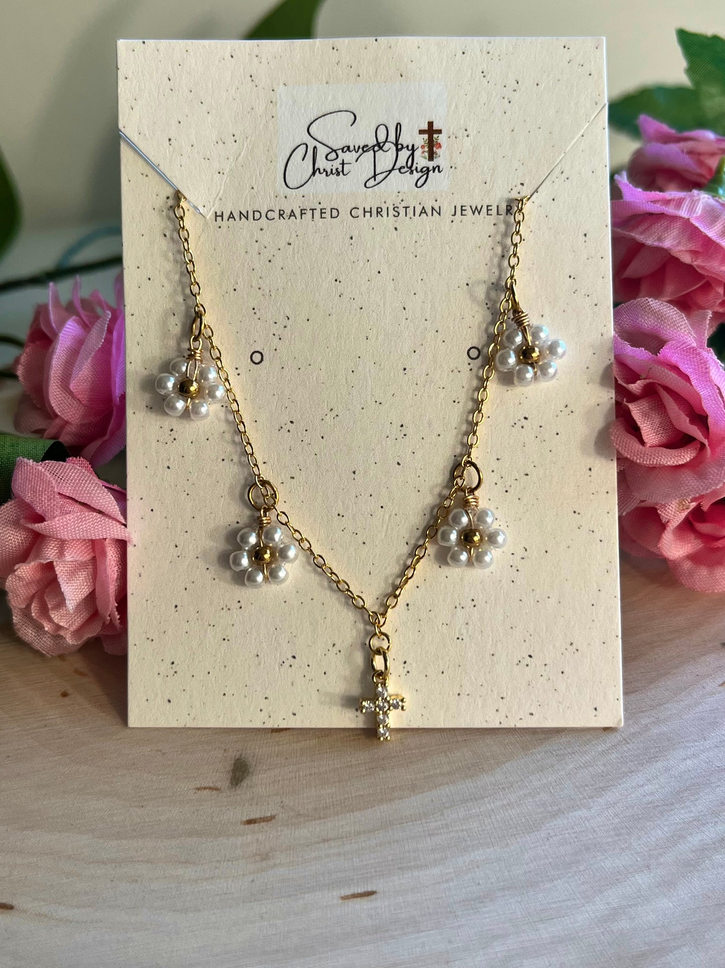 Gold Necklace with 16K gold pendant featuring daisies and a cross.