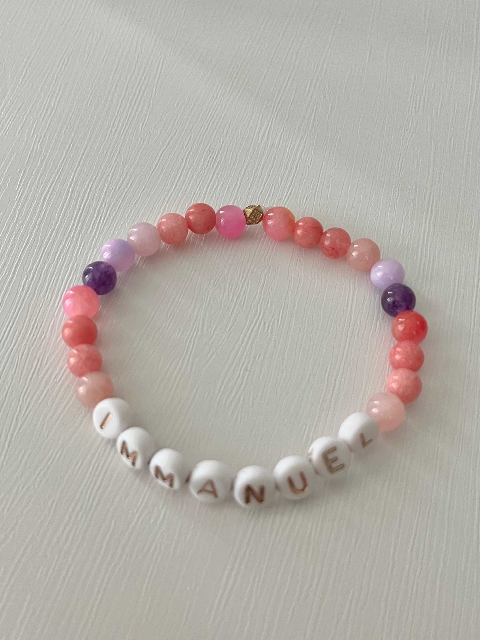 Pink purple IMMANUEL stone beaded braPink Purple IMMANUEL Bracelet showcasing vibrant pink and purple beads, ideal for expressing faith and style in your jewelry collection.celet