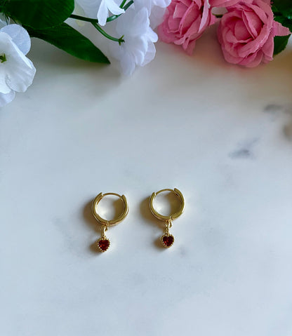 Gold heart huggie hoop earrings with dainty gold-filled heart charms, handmade jewelry for women.
