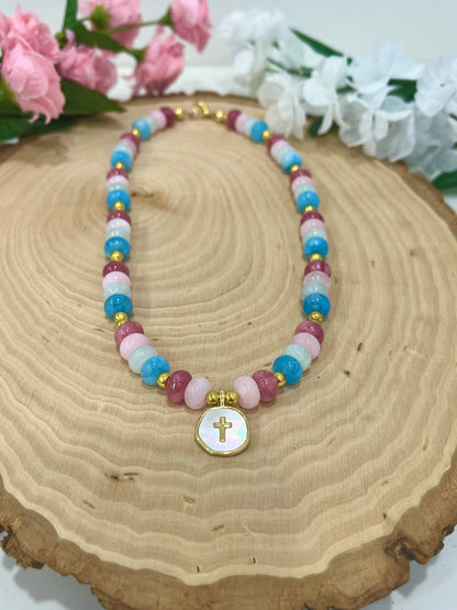 Christian cross necklace with colorful stone beads, gold accents, and pearlescent cross charm