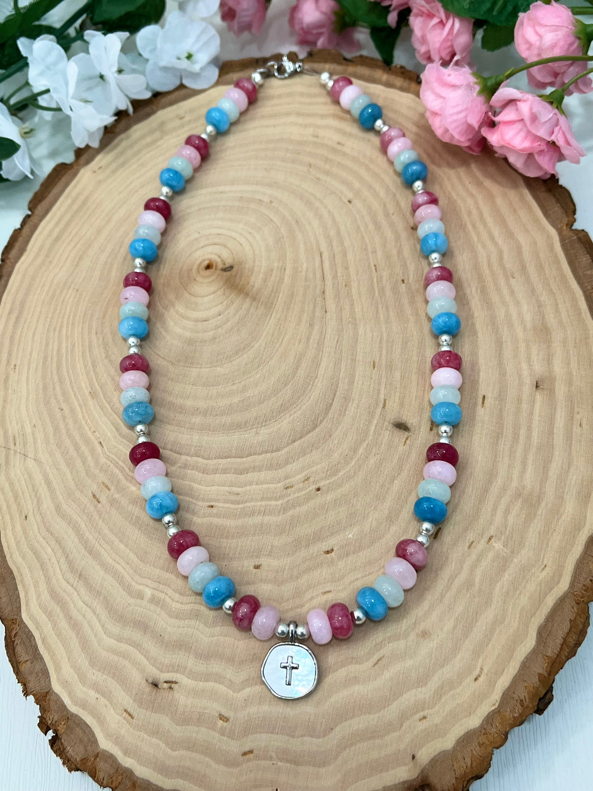Christian cross necklace with colorful stone beads, silver accents, and pearlescent cross charm
