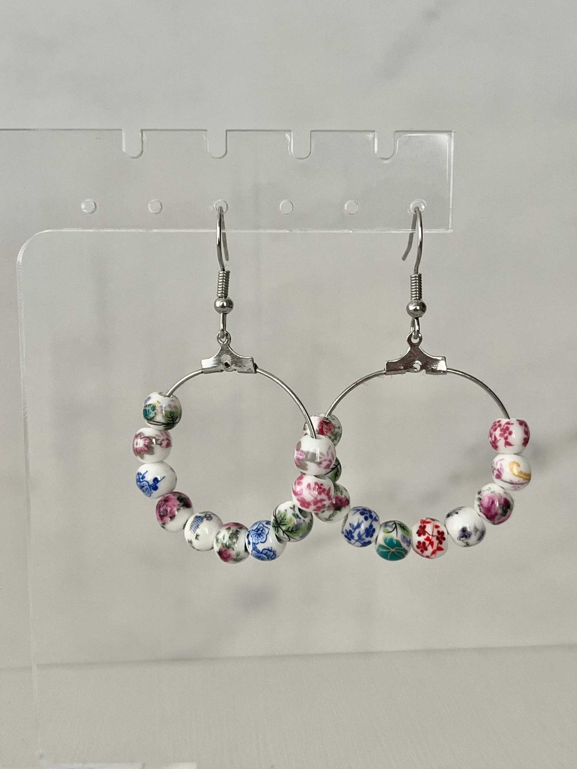 Floral hoop earrings – multicolored beaded silver jewelry with a floral design.


