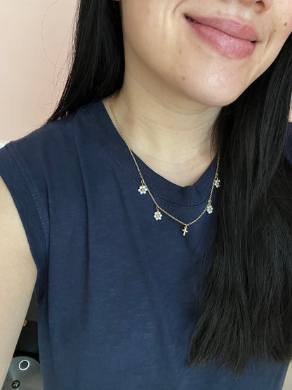 Gold Necklace with 16K gold pendant featuring daisies and a cross.