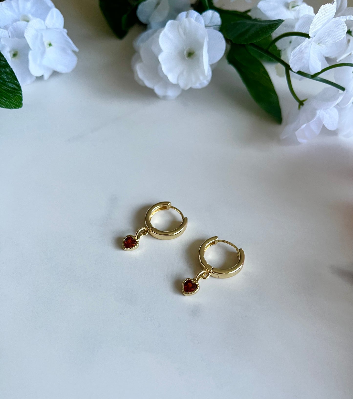 Gold heart huggie hoop earrings with dainty gold-filled heart charms, handmade jewelry for women.