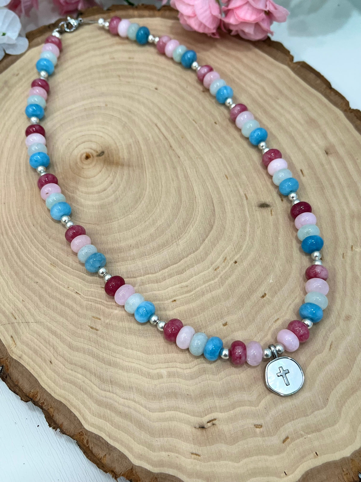 Christian cross necklace with colorful stone beads, silver accents, and pearlescent cross charm
