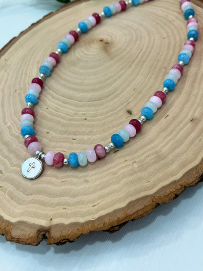 Christian cross necklace with colorful stone beads, silver accents, and pearlescent cross charm