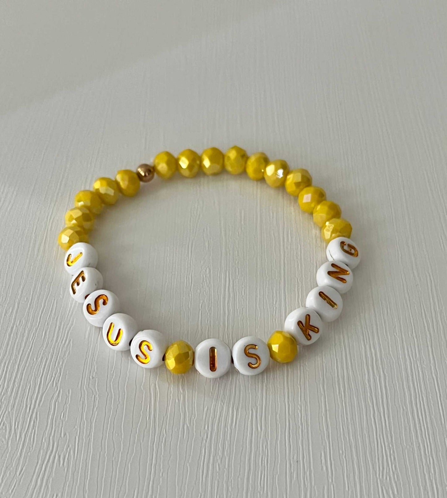 Jesus Is King bead bracelet – vibrant yellow faith-inspired jewelry.

