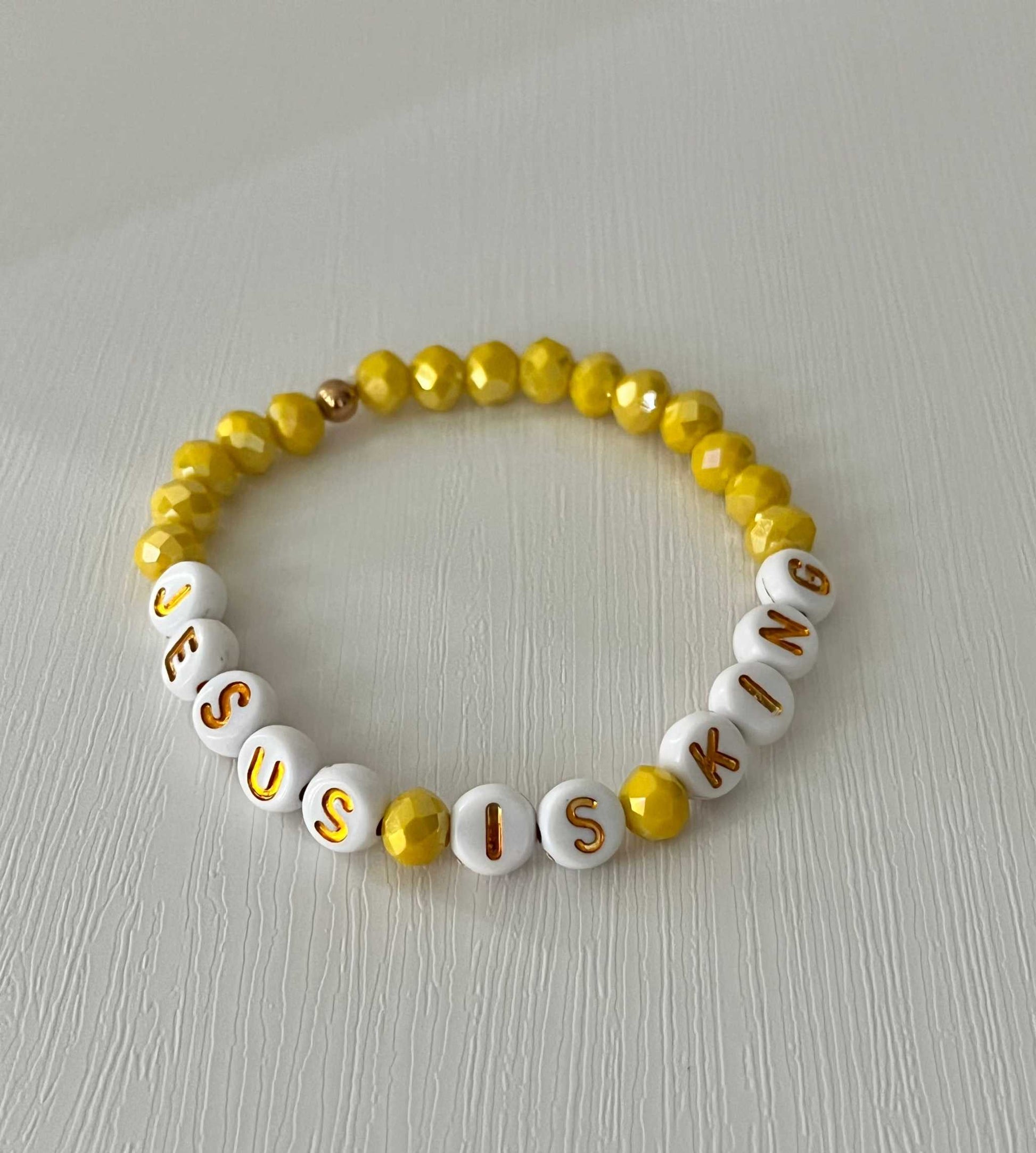 Jesus Is King bead bracelet – vibrant yellow faith-inspired jewelry.

