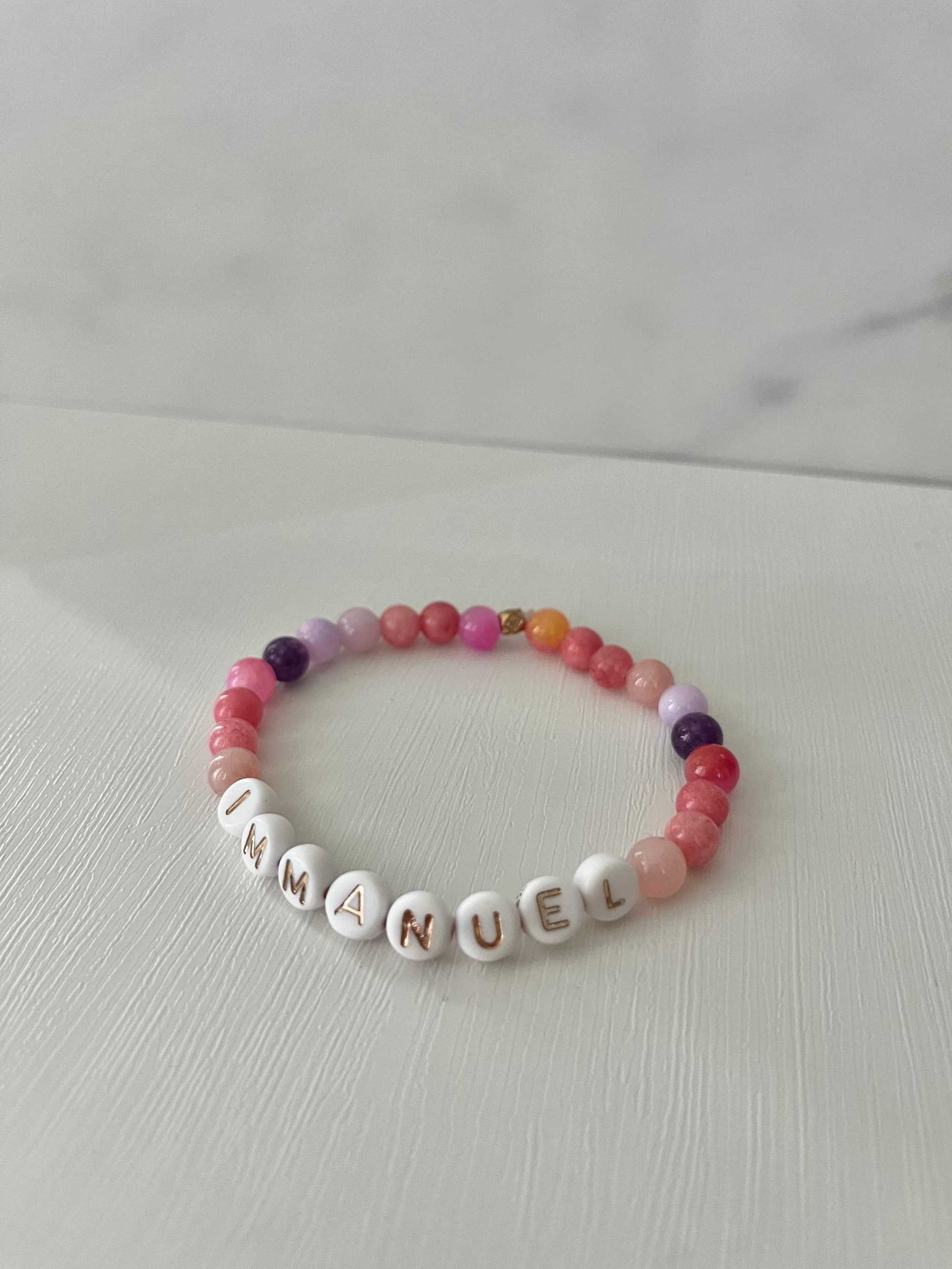 Pink purple IMMANUEL sPink Purple IMMANUEL Bracelet showcasing vibrant pink and purple beads, ideal for expressing faith and style in your jewelry collection.tone beaded bracelet