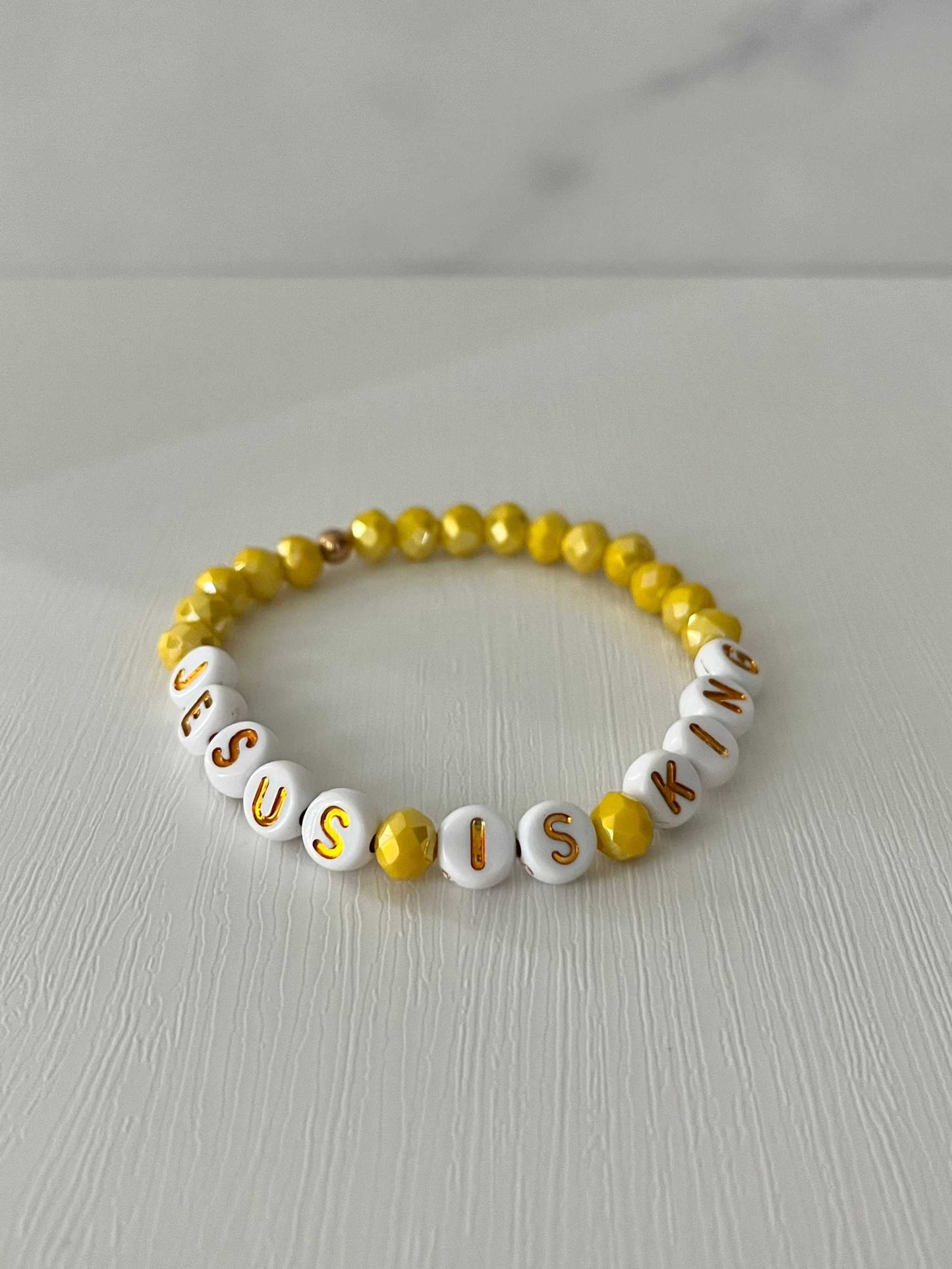 Jesus Is King bead bracelet – vibrant yellow faith-inspired jewelry.

