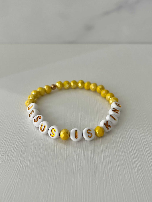Jesus Is King bead bracelet – vibrant yellow faith-inspired jewelry.

