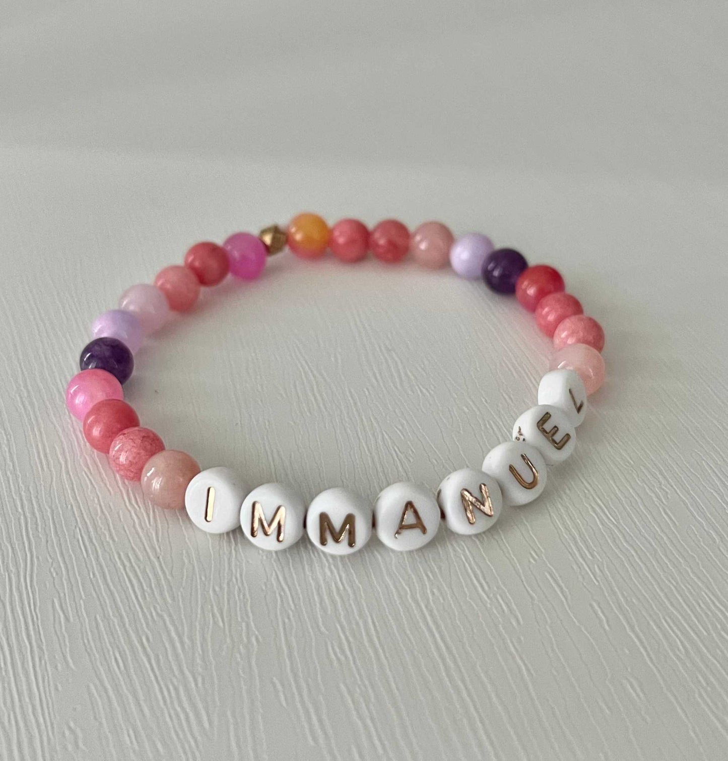 Pink purple IMMANUEL stone Pink Purple IMMANUEL Bracelet showcasing vibrant pink and purple beads, ideal for expressing faith and style in your jewelry collection.beaded bracelet