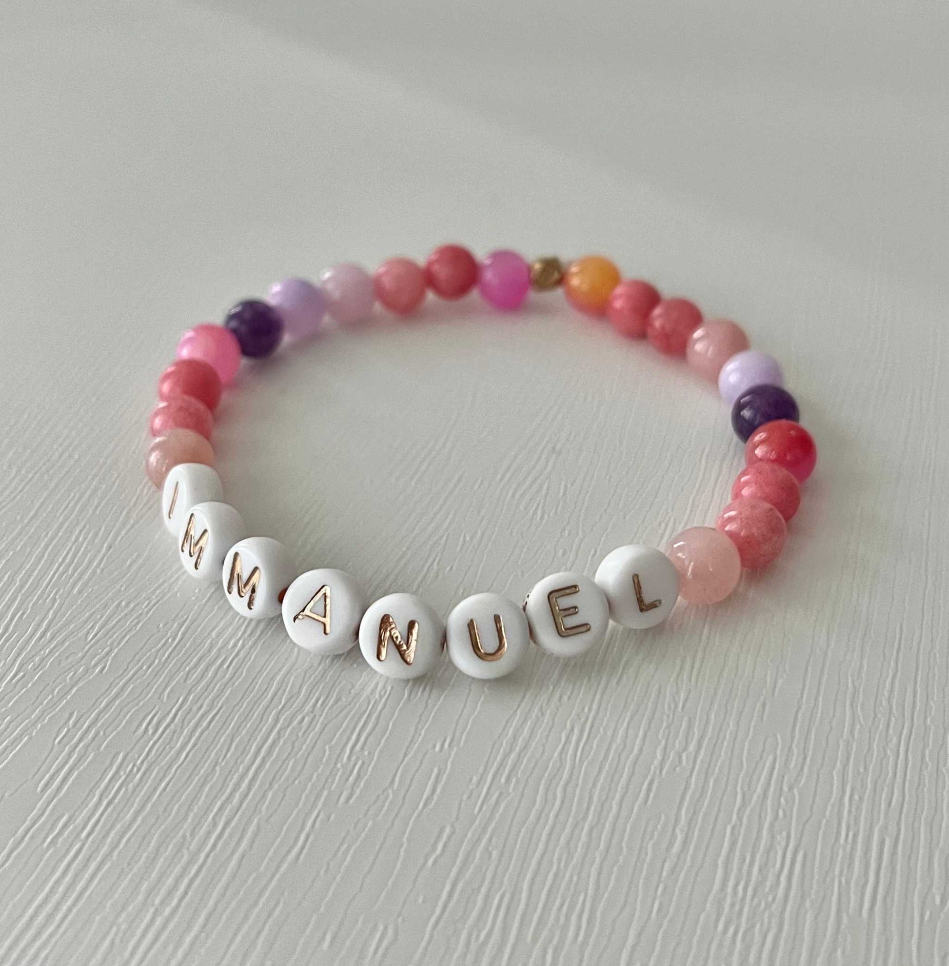 Pink purple IMMANUEL stone beadePink Purple IMMANUEL Bracelet showcasing vibrant pink and purple beads, ideal for expressing faith and style in your jewelry collection.d bracelet
