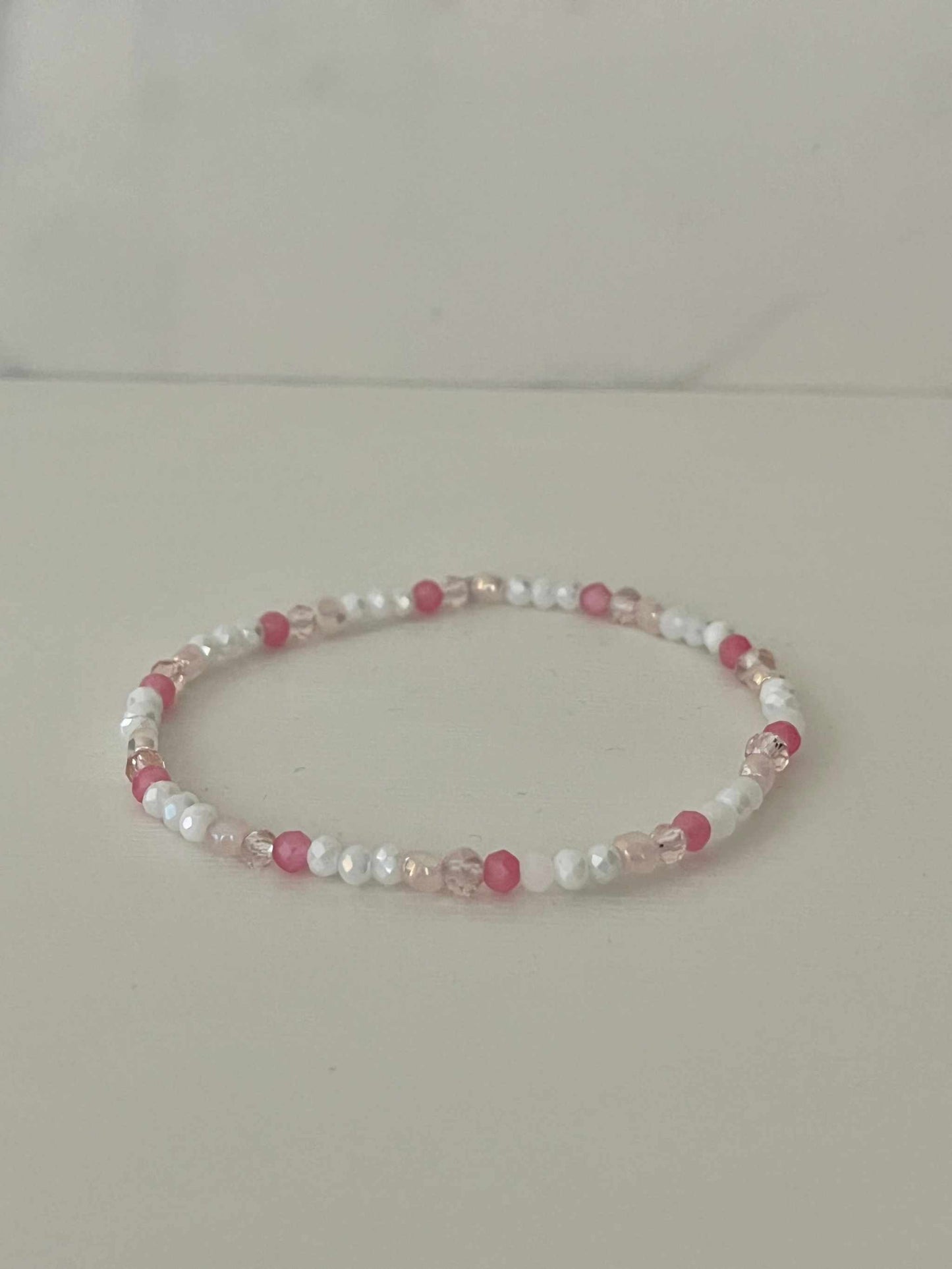 Dainty pink white jeweled crystal bracPink White Crystal Dainty Bracelet featuring delicate jeweled crystals, perfect for adding a touch of elegance to any outfit.elet