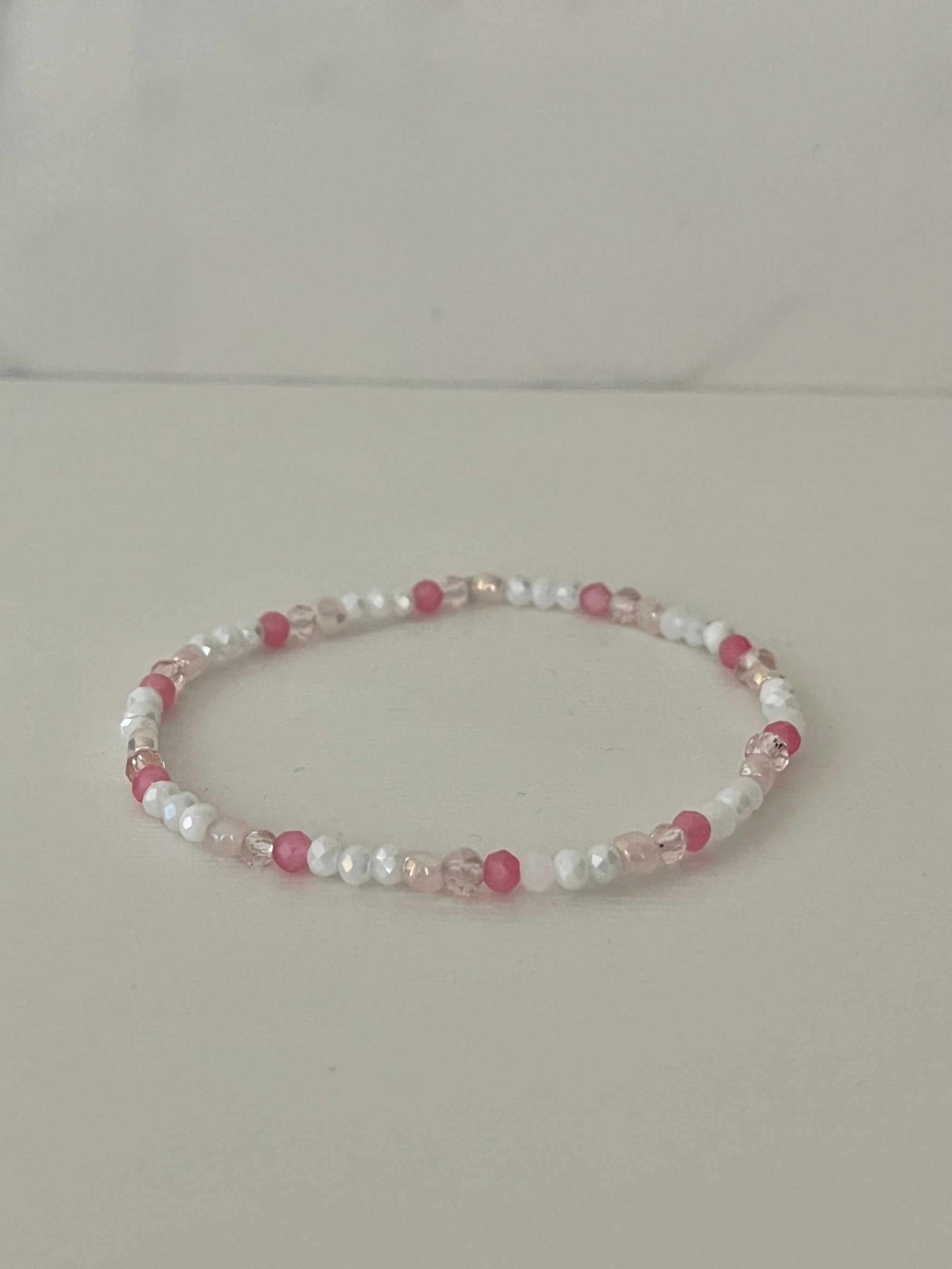 Dainty pink white jeweled crystal bracPink White Crystal Dainty Bracelet featuring delicate jeweled crystals, perfect for adding a touch of elegance to any outfit.elet