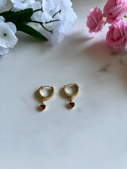 Gold heart huggie hoop earrings with dainty gold-filled heart charms, handmade jewelry for women.