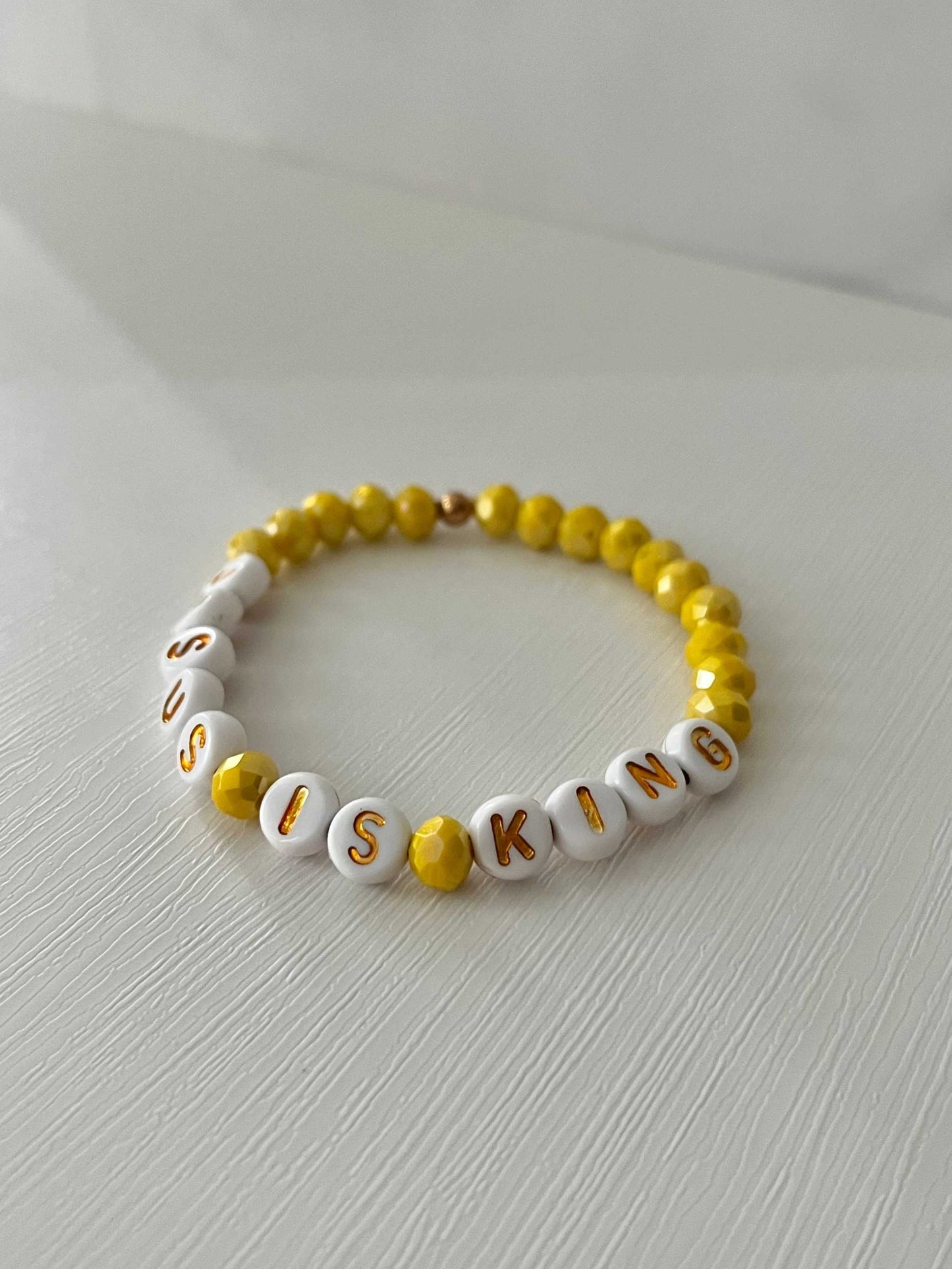 Jesus Is King bead bracelet – vibrant yellow faith-inspired jewelry.

