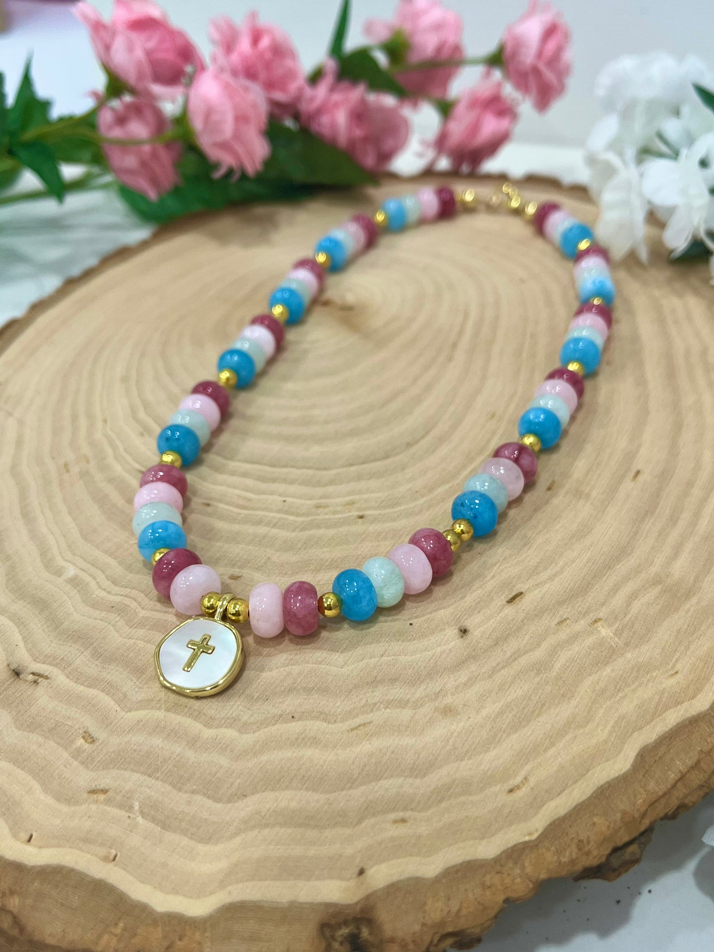 Christian cross necklace with colorful stone beads, gold accents, and pearlescent cross charm