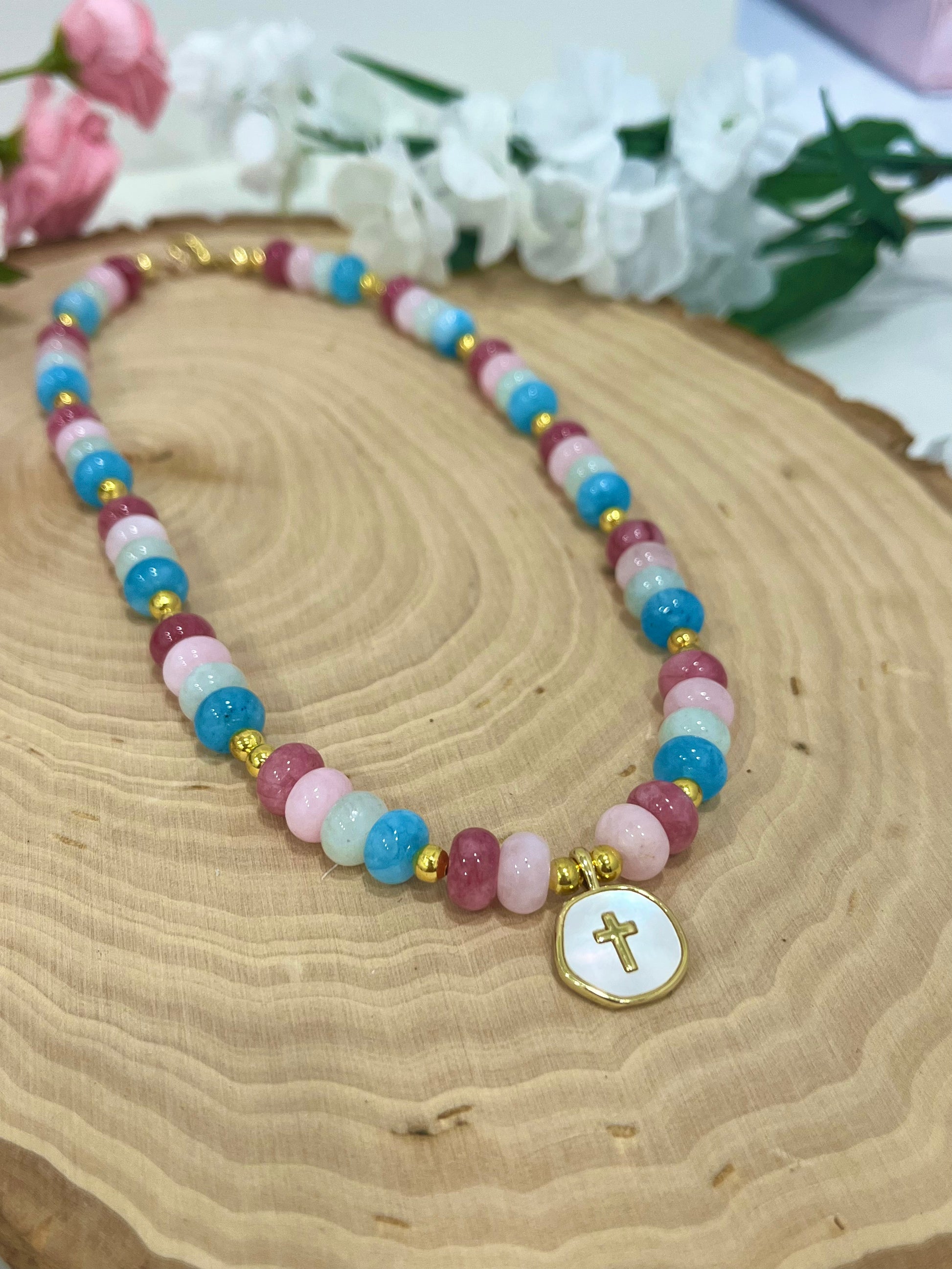 Christian cross necklace with colorful stone beads, gold accents, and pearlescent cross charm