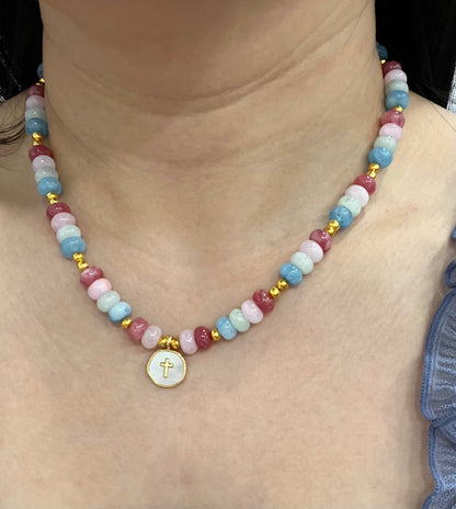 Christian cross necklace with colorful stone beads, gold accents, and pearlescent cross charm