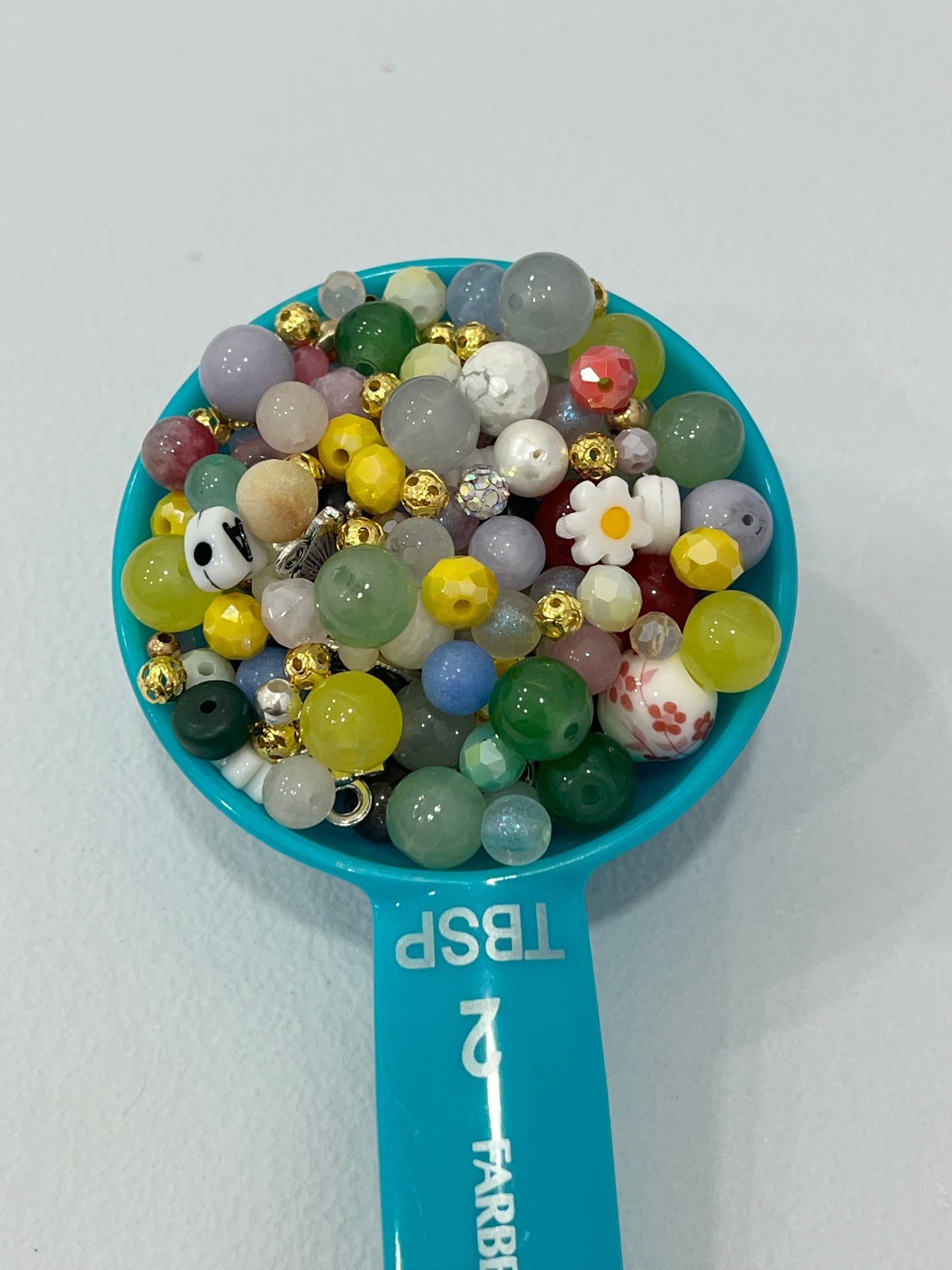 Colorful mystery bead scoop with assorted beads, charms, spacers and jewelry making supplies