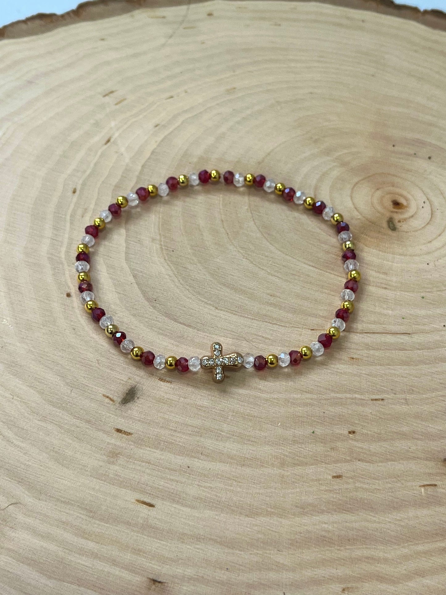 Christmas cross bracelet with red and green crystal beads and gold cross charm.