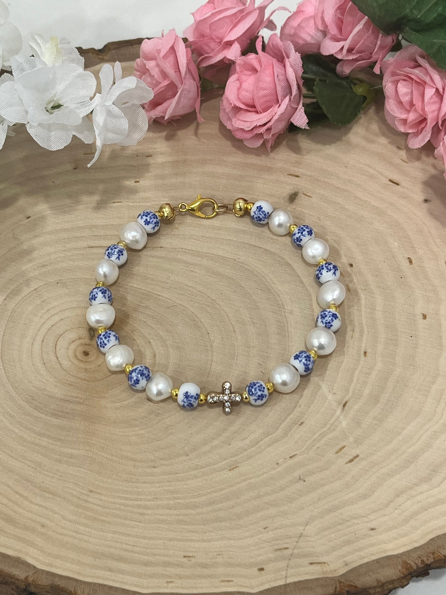 Handmade floral pearl cross bead bracelet with freshwater pearls and cross charm.