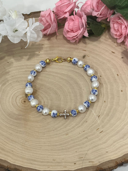Handmade floral pearl cross bead bracelet with freshwater pearls and cross charm.