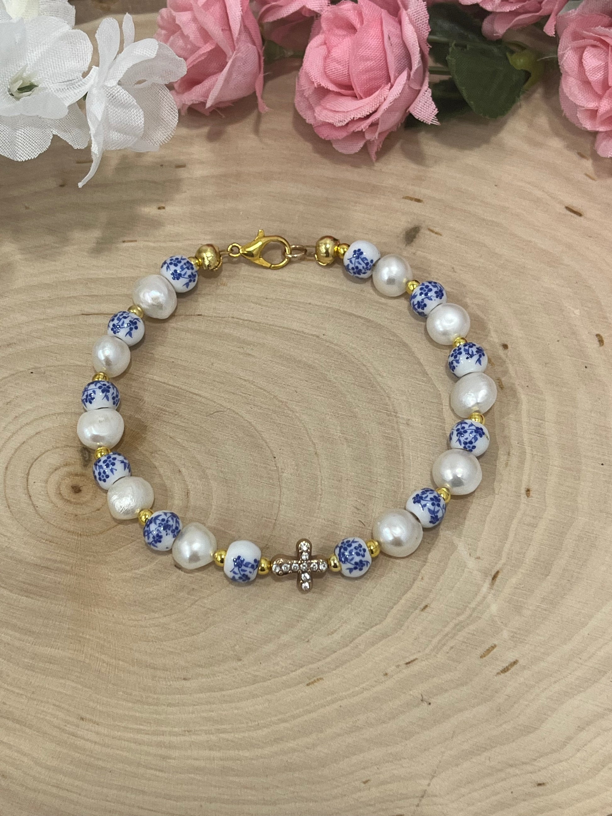 Handmade floral pearl cross bead bracelet with freshwater pearls and cross charm.