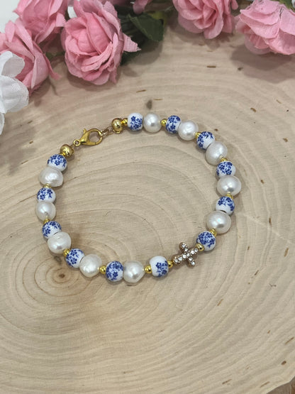 Handmade floral pearl cross bead bracelet with freshwater pearls and cross charm.