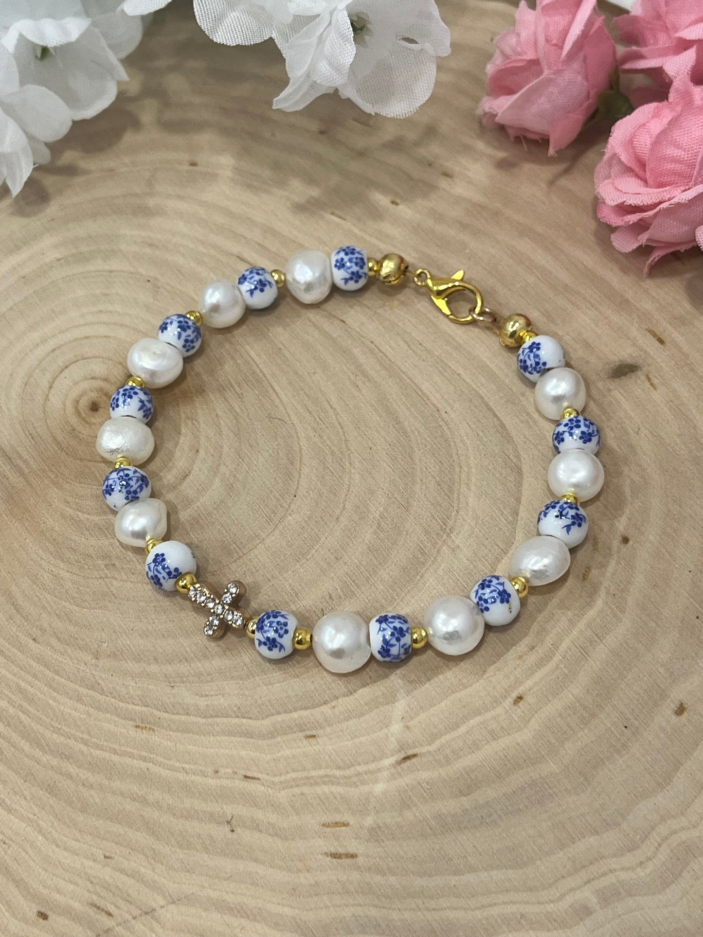 Handmade floral pearl cross bead bracelet with freshwater pearls and cross charm.