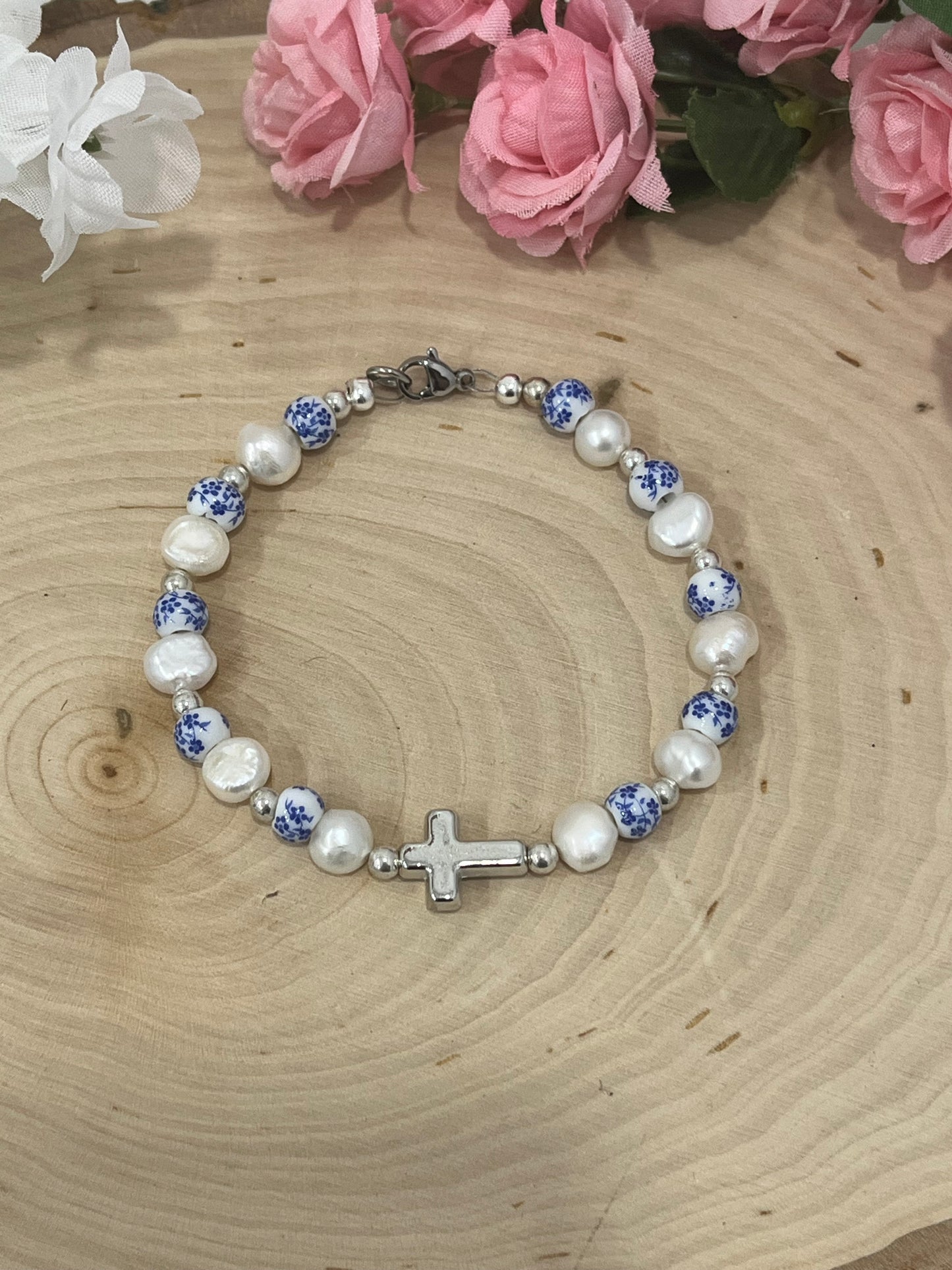 Handmade floral pearl cross bead bracelet with freshwater pearls and cross charm.
