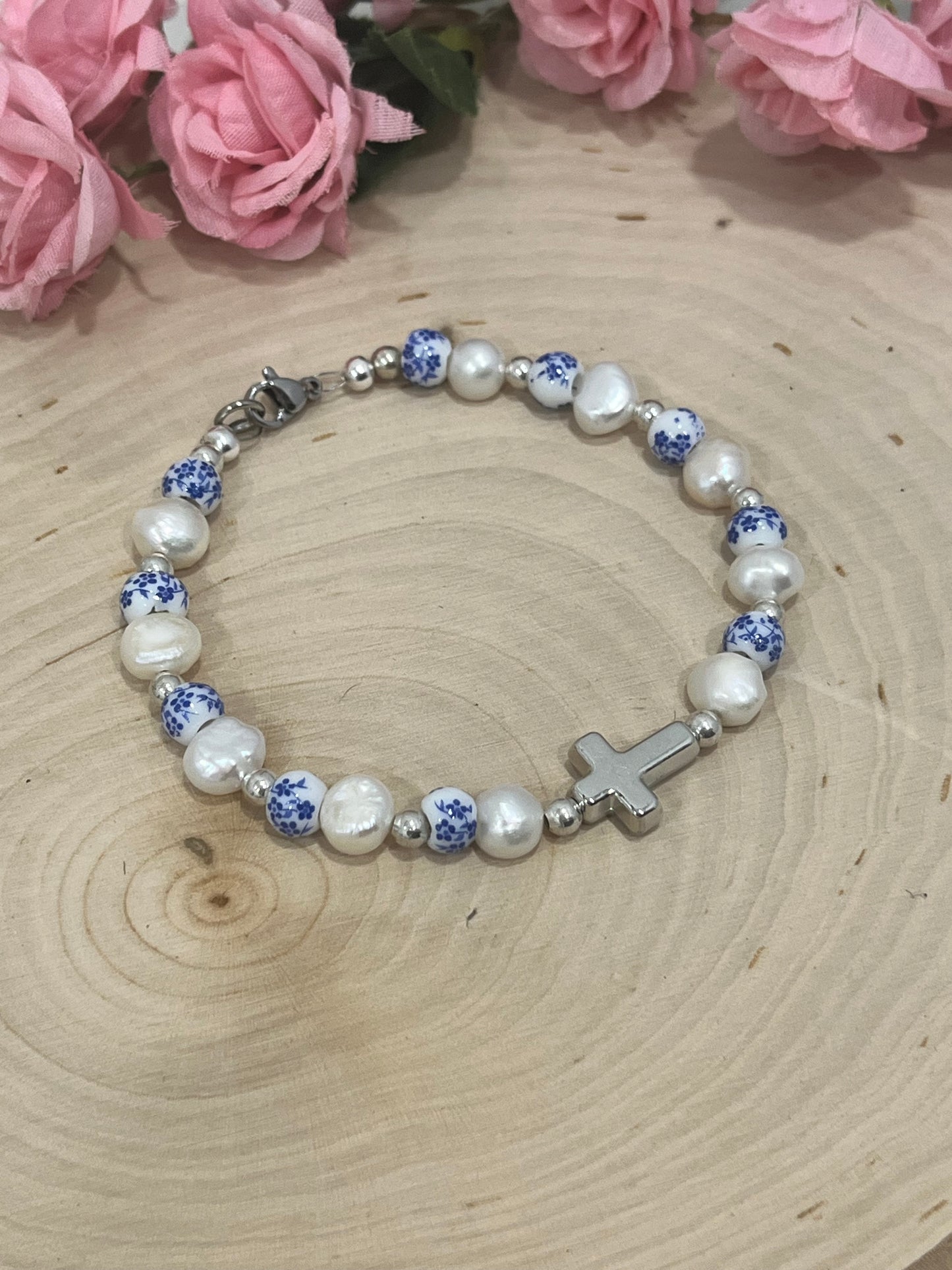 Handmade floral pearl cross bead bracelet with freshwater pearls and cross charm.