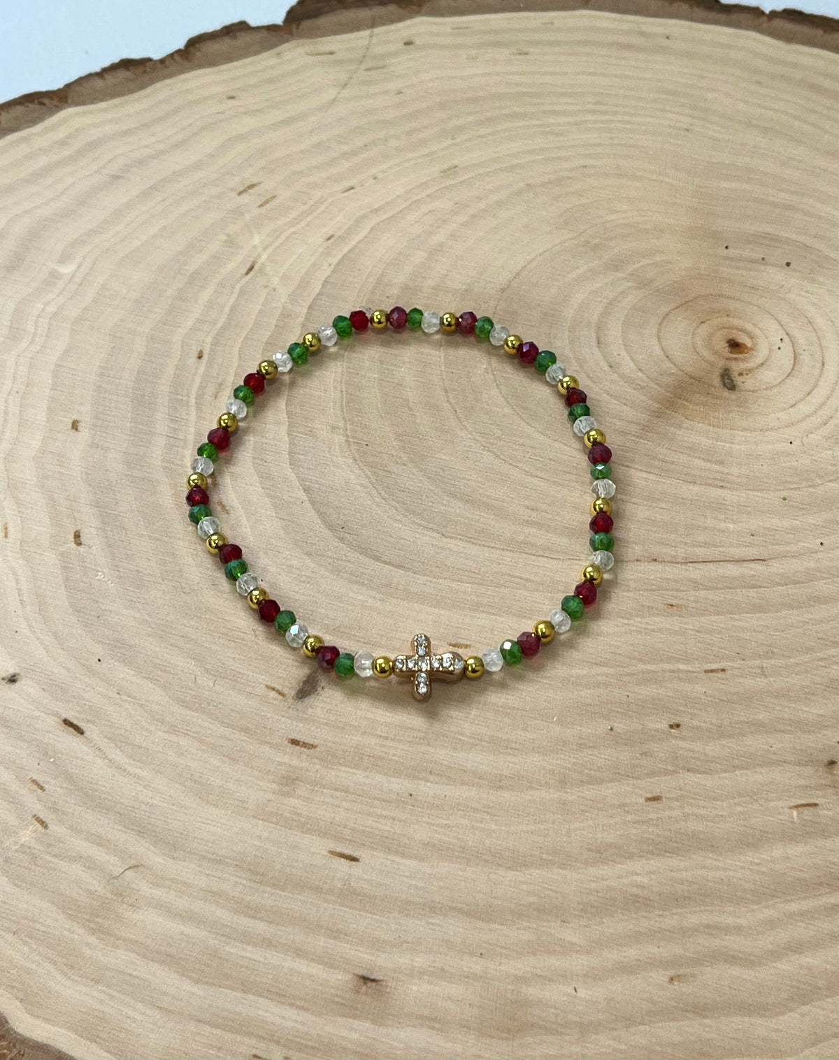 Christmas cross bracelet with red and green crystal beads and gold cross charm.